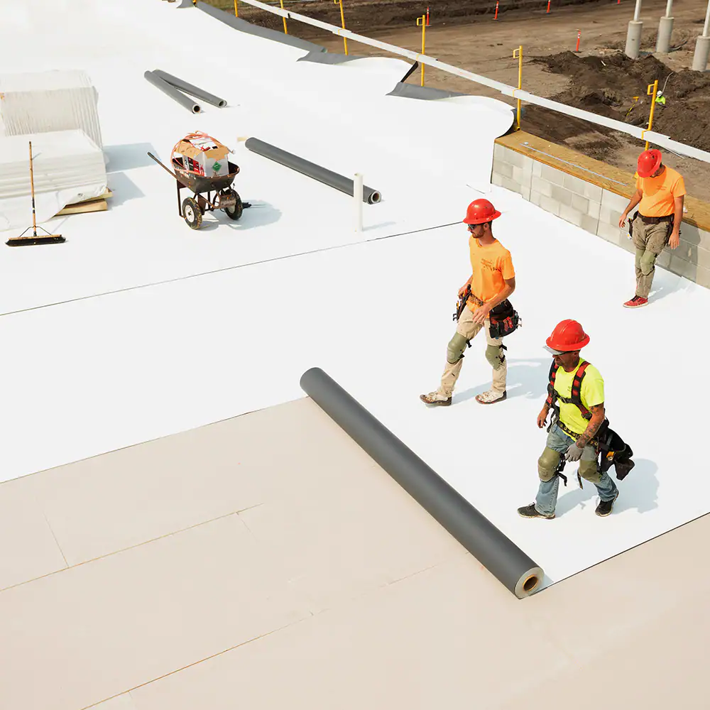 White pickup truck in front a home that just had new shingles installed by workers
